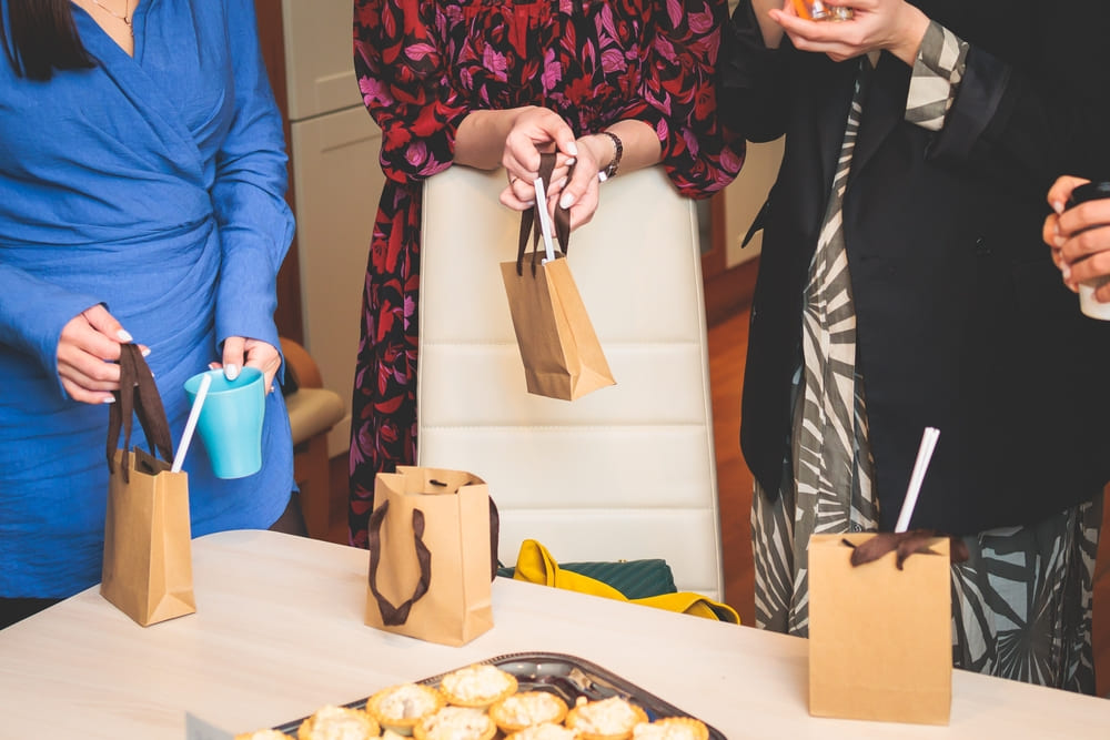 Corporate employees gift giving of branded merchandise in Heat Transfer Vinyl and UV Printed paper bags