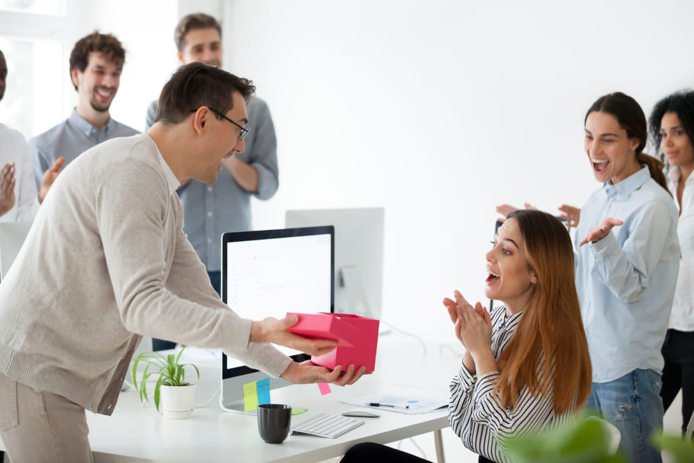 Giving a branded custom promotional items as a gift of appreciation to an employee