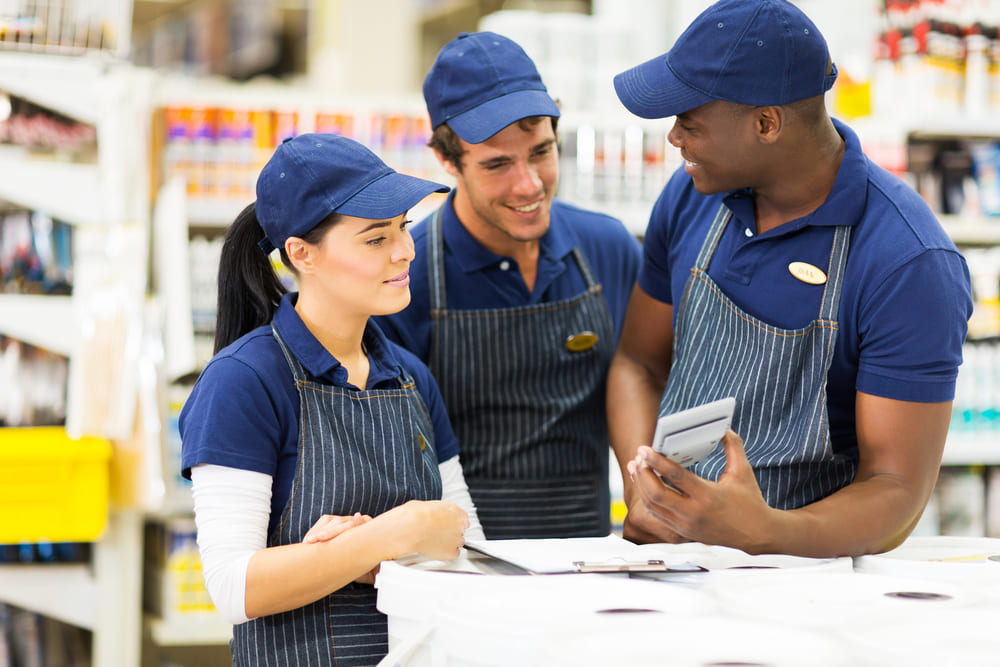 Happy employees wearing custom shirts workwear