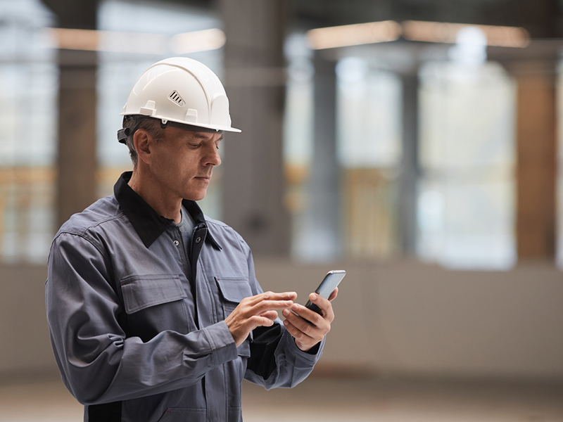 Man in tradie workwear researching for embroidery service in Perth
